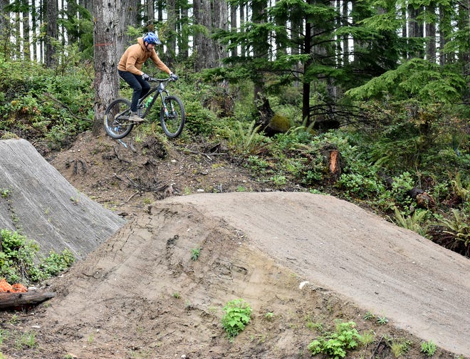 Matt Blossom, vice president of Evergreen Mountain Bike Alliance’s West Sound Chapter, completes a jump at Port Gamble Ride Park.