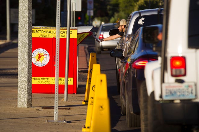 People line up to drop their primary election ballots at the drop box across the street from the Yakima County Courthouse, Tuesday, Aug. 2, 2022, in Yakima, Wash.