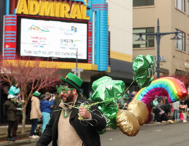 Bremerton City Council's Quinn Dennehy rushes down Pacific Avenue to catch up with his parade group after stopping to hand out candy to kids during the 29th. Annual St. Patrick's Day Parade in downtown Bremerton on Saturday, March 11, 2023.