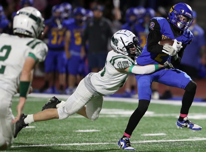 Port Angeles’s Aiden Otis (45) tackles Bremerton’s Trenton Bulmer (2) during their game at Bremerton Memorial Stadium on Friday, Oct. 6, 2023. The Bremerton Knights won the game 49-7.