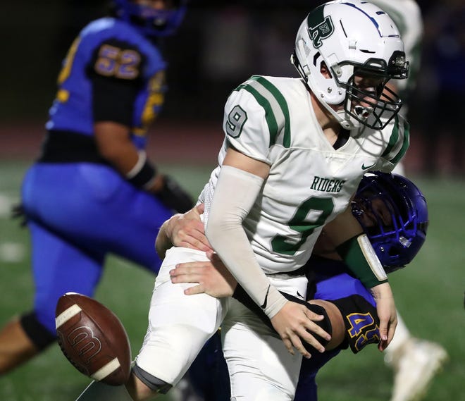 Bremerton’s Lars Michaelson (45) forces a fumble from Port Angeles’s Brandt Perry (9) on Friday, Oct. 6, 2023. A facemask penalty was called on Michaelson on the play.