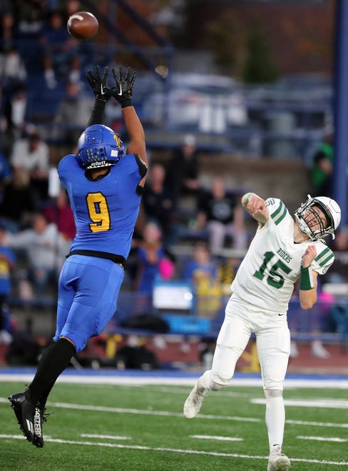 Bremerton’s James Penitusi (9) puts pressure on Port Angeles quarterback Parker Nickerson (15) as he passes the ball on Friday, Oct. 6, 2023.