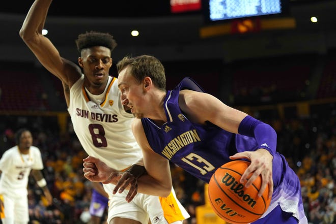 Washington Huskies forward Moses Wood (13) dribbles against Arizona State Sun Devils forward Alonzo Gaffney (8) during the first half at Desert Financial Arena.