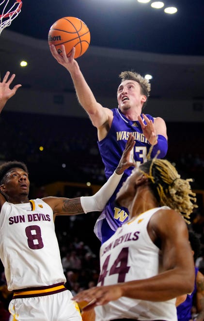 Washington forward Moses Wood (13) makes a layup against ASU forward Alonzo Gaffney (8) during a game at Desert Financial Arena.