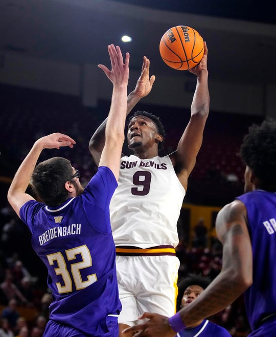 ASU center Shawn Phillips Jr. (9) shoots against Washington center Wilhelm Breidenbach (32) during a game at Desert Financial Arena.