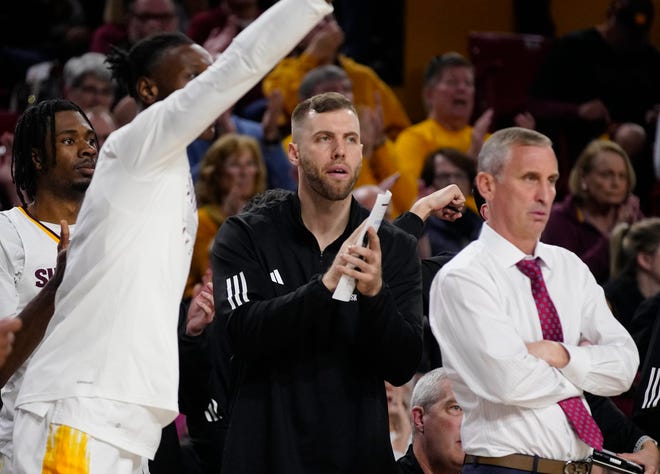 ASU assistant Mickey Mitchell claps for the team during a game against Washington at Desert Financial Arena.