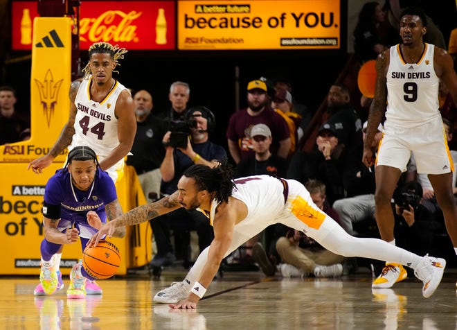 ASU guard Frankie Collins (1) steals the ball against Washington guard Koren Johnson (0) during a game at Desert Financial Arena.