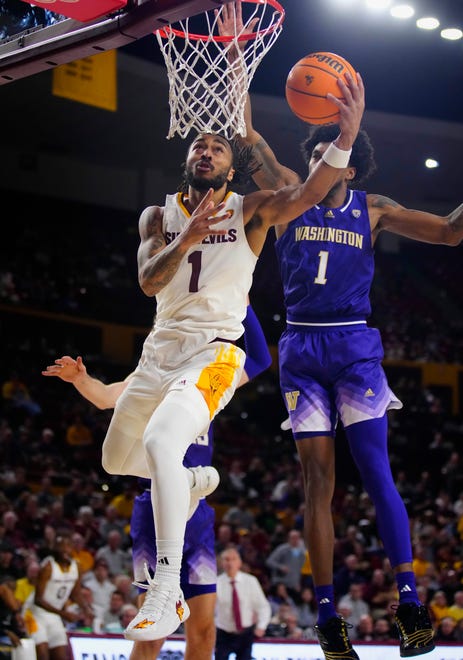 ASU guard Frankie Collins (1) makes an acrobatic layup against Washington Keion Brooks Jr. (1) during a game at Desert Financial Arena.