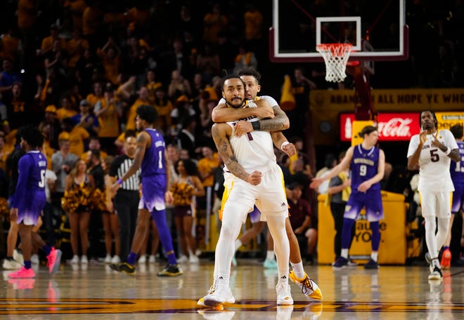 ASU guard Jose Perez (12) hugs guard Frankie Collins (1) after a game-tying basket against Washington during a game at Desert Financial Arena.