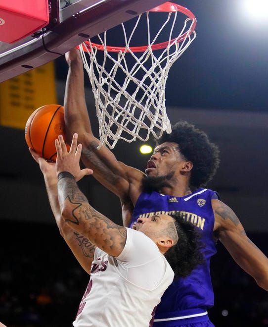 Washington guard Keion Brooks Jr. (1) blocks a shot from ASU guard Jose Perez (12) during a game at Desert Financial Arena.