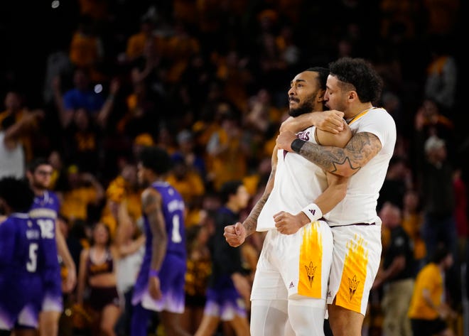 ASU guard Jose Perez (12) hugs guard Frankie Collins (1) after a game-tying basket against Washington during a game at Desert Financial Arena.