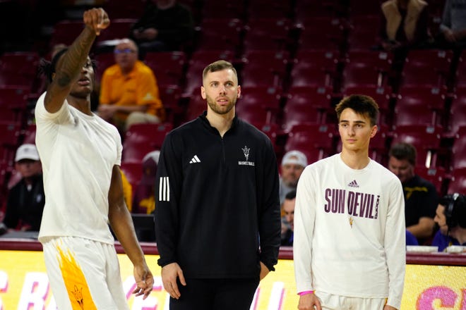 Former ASU forward Mickey Mitchell watches warmups prior to a game at Desert Financial Arena.