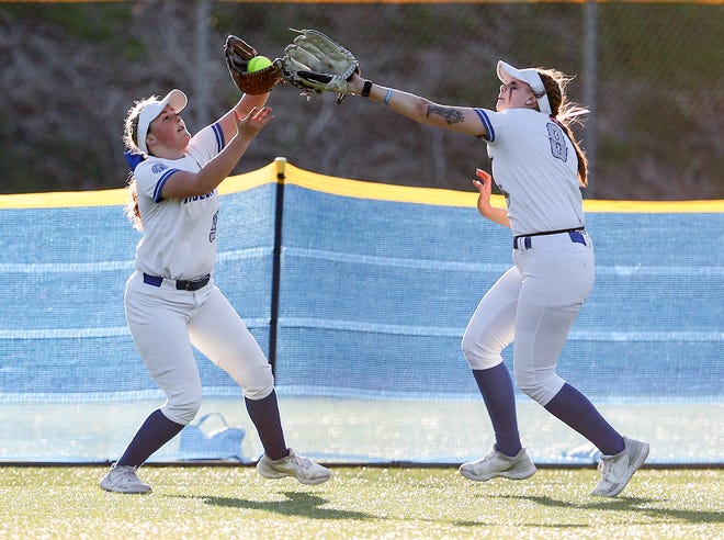 Olympic’s Hannah Linn (9) is backed up by Maddie Miller (8) as she catches a fly ball for a North Kitsap out at Lobe Fields on Tuesday, March 19, 2024.