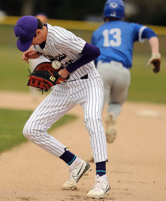 North Kitsap’s Aaron Groetsch bobbles the ground ball he scooped up but is able to hold on to it for an Olympic out at first on Wednesday, March 20, 2024.