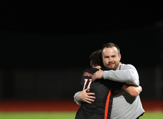 Central Kitsap head coach Patrick Leonard hugs player Silas Gholston after their 2-1 win over Gig Harbor in Silverdale on Thursday, March 21, 2024.