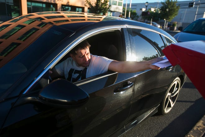 Jacobo Macias drops his primary election ballot at the drop box across the street from the Yakima County Courthouse Tuesday, Aug. 2, 2022 in Yakima, Wash.