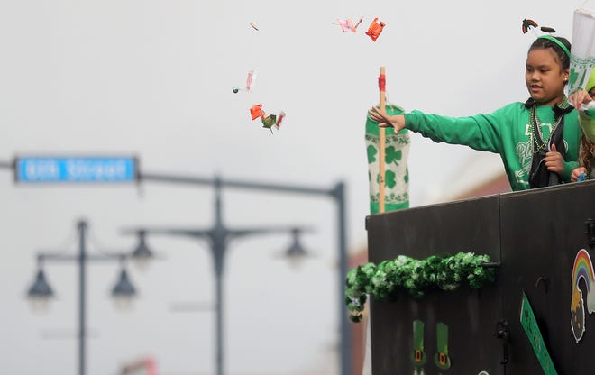 Candy is tossed from the back of the Tim Ryan Construction float during the 29th Annual St. Patrick's Day Parade in downtown Bremerton on Saturday, March 11, 2023.