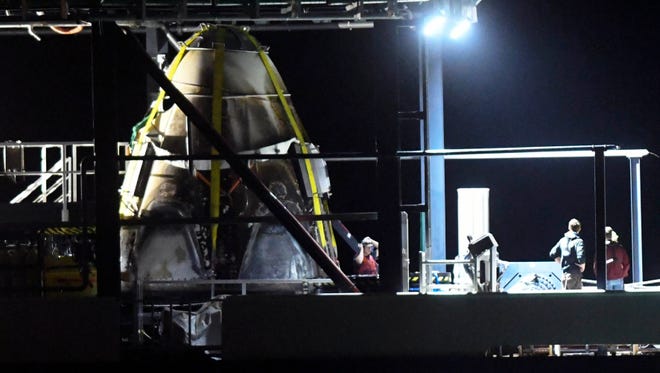 The SpaceX Crew Dragon capsule aboard the support ship Go Searcher, returns to Port Canaveral March 9, 2019. The capsule, launched aboard a Falcon 9 rocket last week, made a trip to the International Space Station before returning to Earth.